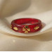 Red Acrylic Ring with Gold Clover Design